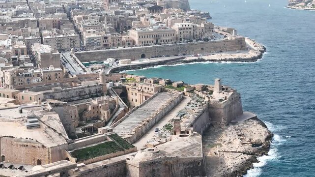 fort st elmo aerial view harbourside valletta malta overcast sky rough sea grand harbour coastal fortification peninsula star fort layout limestone rampart drone footage bastion wall texture