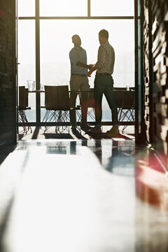 Businessmen, meeting and hallway with handshake in office for agreement, partnership or hiring. Male people, employees or colleagues shaking hands in corridor boardroom for onboarding deal together