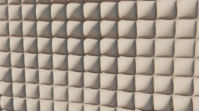 Puffy quilted fabric wall, soft padded cream panels inflating in a slow wave, seamless looping 3D background