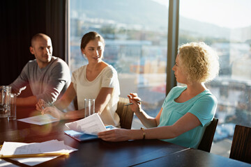 Fototapeta premium Team, meeting and paperwork in office with discussion, creative strategy and brand awareness project. Marketing, people and talk in boardroom with documents, campaign management and media planning.