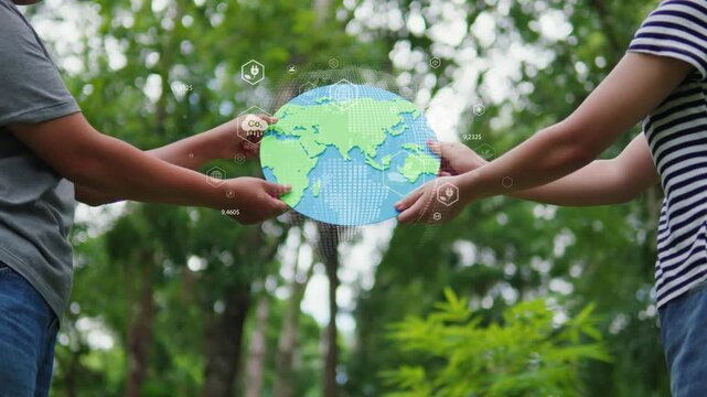 Two people holding paper planet earth together in green forest with ESG virtual icons, environmental care and community collaboration concept