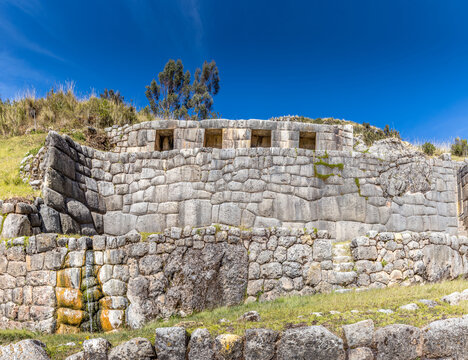 Ancient Inca fortress of Puka Pukara with finely crafted stone walls set in the Andean highlands under a clear blue sky