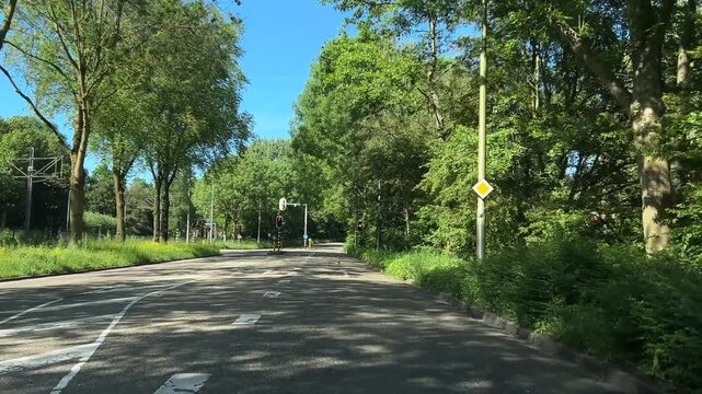 Amsterdam suburbs, Amstelveen, Suburban Amsterdam road scene with roundabout and greenery