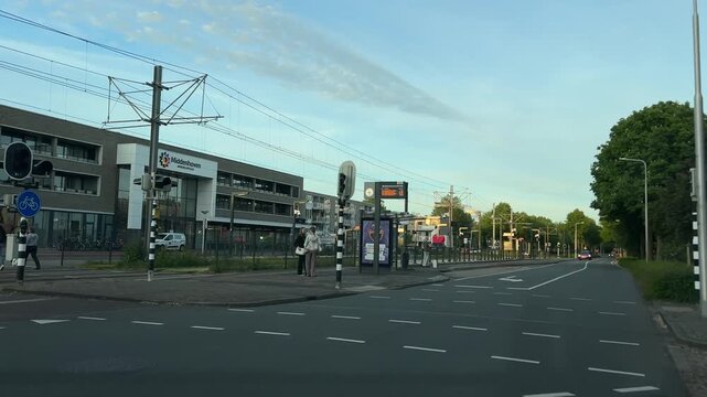 Amsterdam suburbs, Amstelveen, Curved suburban Amstelveen street with tram lines and modern