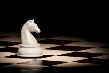 White chess knight piece standing on a classic checkered chessboard, with a dark, moody background. Represents intelligence, strategy, and focus. Chess background. © Roystock