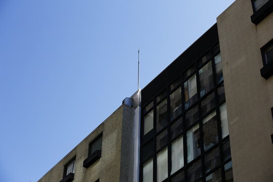 Modern Building Rises Beneath a Clear Blue Sky.
