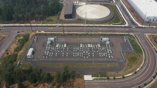 4K aerial drone footage of a modern electrical power substation in Sherwood, Oregon, USA. High voltage grid infrastructure supplying electricity to nearby industrial and commercial facilities