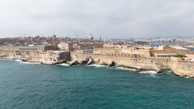 fort st elmo aerial view coastal cliffs valletta malta overcast sky rough sea grand harbour coastal fortification peninsula limestone rampart drone footage internationally recognized heritage site
