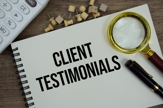 Client Testimonials text written on notepad with calculator and magnifying glass flat lay on wooden background