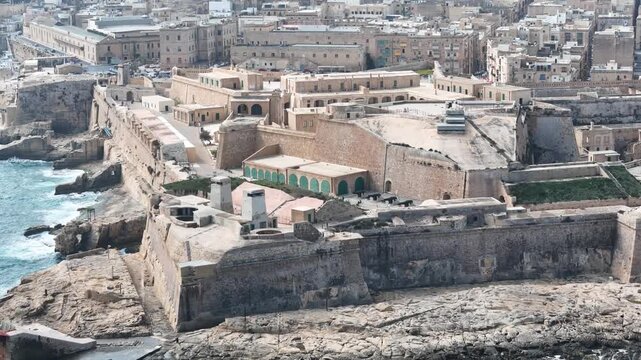 fort st elmo aerial view courtyard visible valletta malta overcast sky rough sea grand harbour coastal fortification peninsula star fort layout drone internationally recognized heritage site