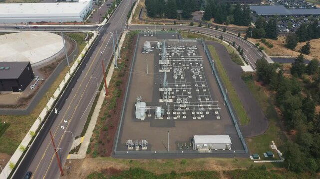 4K aerial drone footage of a modern electrical power substation in Sherwood, Oregon, USA. High voltage grid infrastructure supplying electricity to nearby industrial and commercial facilities