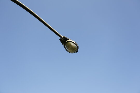Street Lamp Extends Across a Clear Blue Sky.