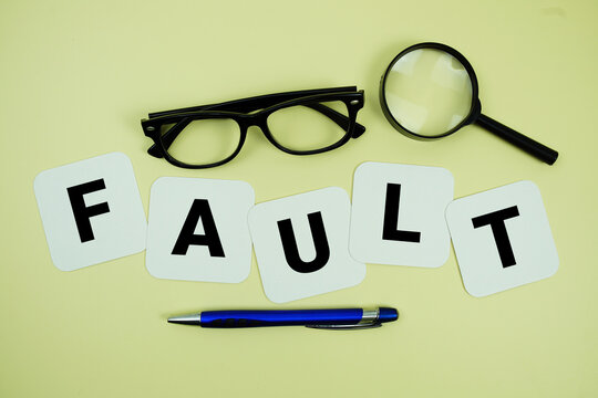 FAULT alphabet letters with magnifying glass, eye glasses and pen on yellow background
