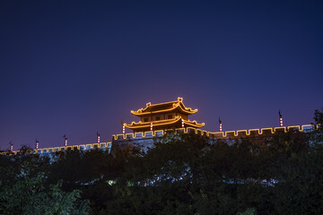 Illuminated Chinese Pagoda and Fortress Wall at Night © TrinhVan