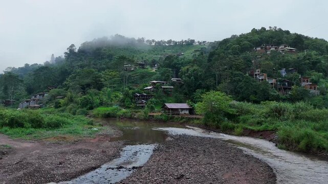 Aerial video showing mountains and morning mist in a rural village in Nan Province, northern Thailand.
