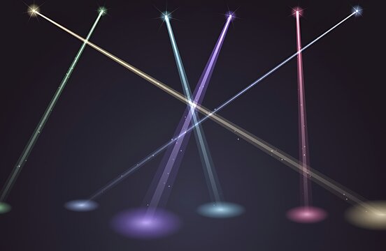 Colorful concert stage spotlights intersecting on dark background