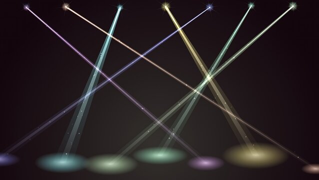 Colorful concert stage spotlights intersecting on dark background