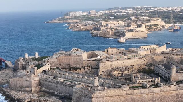 fort st elmo aerial view marsamxett harbour side golden hour valletta malta warm evening light coastal fortification peninsula star fort layout internationally recognized heritage site siege of malta