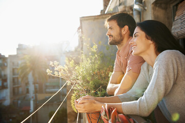 Obraz premium Thinking, couple and smile at house on balcony, love and bonding together on calm morning. Happy, people and daydreaming on terrace for stress relief, affection and sightseeing view for weekend break