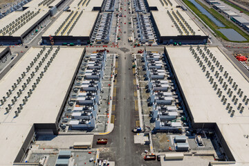 Naklejka na ściany i meble Aerial view of the data center buildings, large AI center structure surrounded by cooling and power systems 