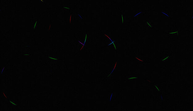 Abstract background with faint colorful light streaks on black