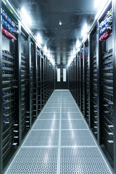 Server racks in modern data center corridor