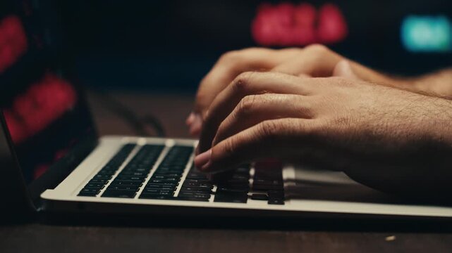 Man Typing on Laptop