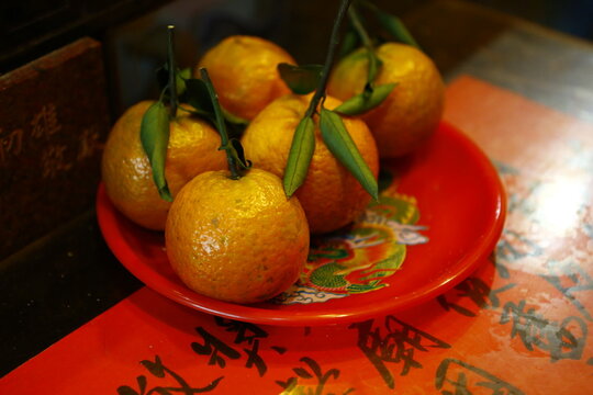 Fresh mandarins placed on a tray as a temple offering.