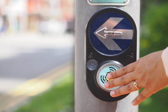 Requesting to cross at a pedestrian signal in the city