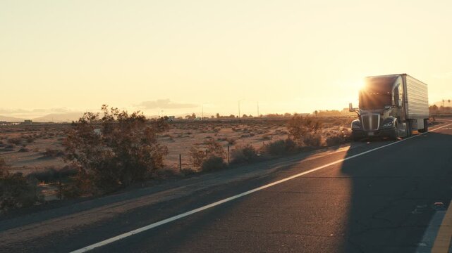 Semi-truck pulling over on desert highway at sunset