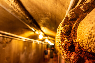 Warm lit brick archway tunnel with hanging industrial lights © kodai