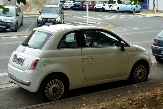 St- Amand Montrond - France - 5 August 2026- Side view of a white Fiat 500 parked on a quiet street in France. Editorial image featuring the iconic Italian city car.	