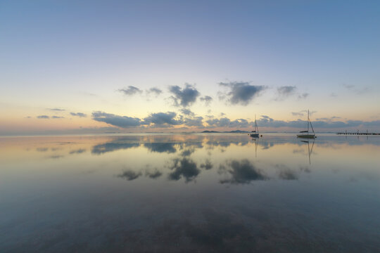 View of the Mar Menor at dawn with two boats on its waters, Punta Prima, Cartagena, Region of Murcia, Spain