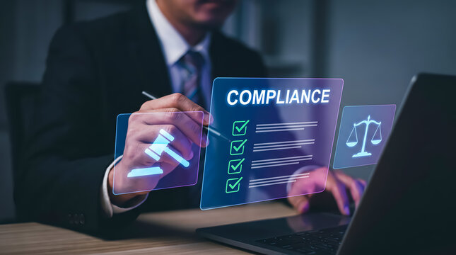 Businessman interacting with a holographic screen displaying a compliance checklist, gavel, and scales of justice icons