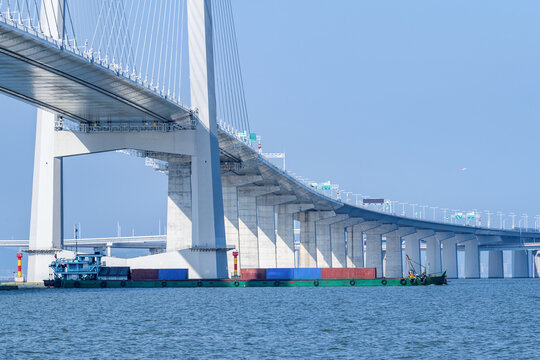 A container ship passing beneath the cross-sea bridge of China's Shenzhen-Zhongshan Link.
