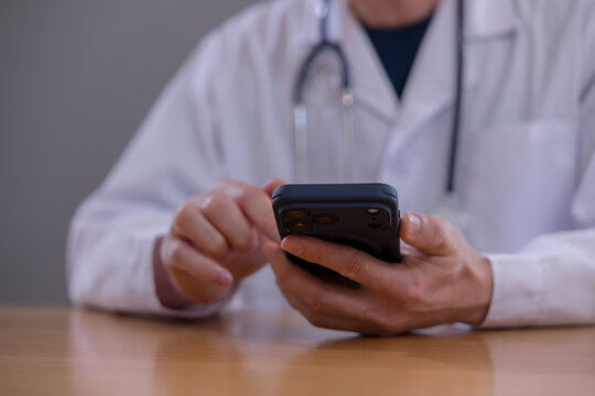 Mobile healthcare healthcare technology and connected care Doctor using smartphone to access patient information in a modern clinic