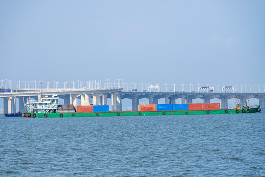 A container ship passing beneath the cross-sea bridge of China's Shenzhen-Zhongshan Link.