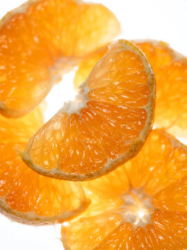 Extreme Macro Backlit Orange Wedge with Glowing Juicy Texture