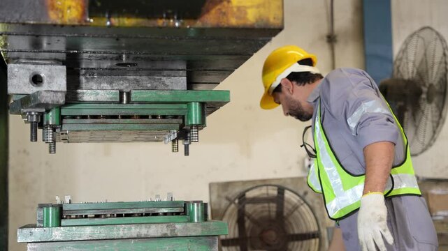 Industrial workers working and control machine at auto parts factory