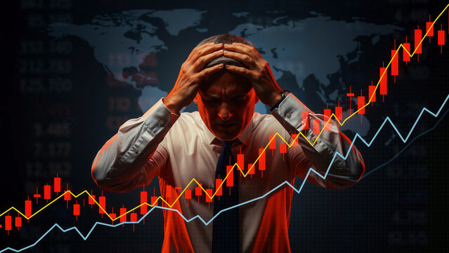 Stressed businessman holding his head amidst volatile stock market charts. Trader facing financial loss with red declining candlesticks and global map. Economic crisis and bankruptcy concept.