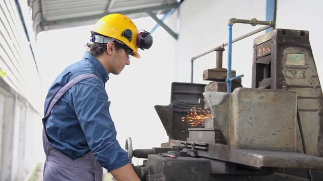 Industrial workers working and control machine at auto parts factory