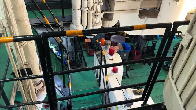 View into the engine room of a passenger ferry with visible machinery, pipes and mechanical equipment during a sea voyage. High quality 4k footage