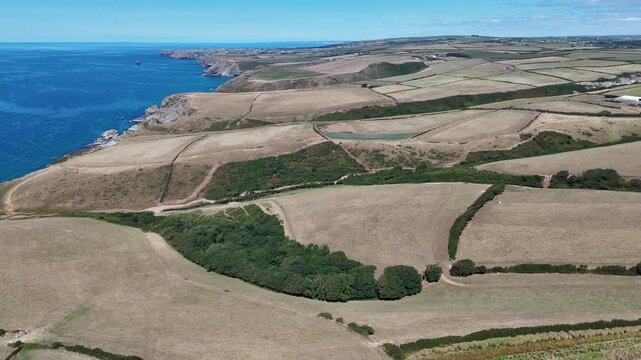 Sideways Drone Flight Along Coastal Farmland and Rugged Cliffs in Cornwall