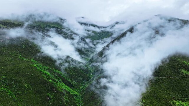 Aerial view of the summer landscape in Shuangqiao Valley Scenic Area of Mount Siguniang, Aba Prefecture, Sichuan, China, with mist-shrouded mountains