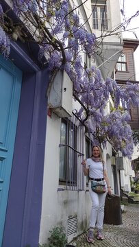 Woman stroll through the old streets of Istanbul with a view of the Bosphorus. Beautiful narrow streets with a rich cultural heritage.
