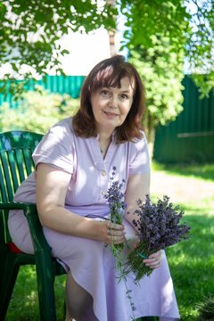 Woman Arranging Lavender Flowers Outdoors