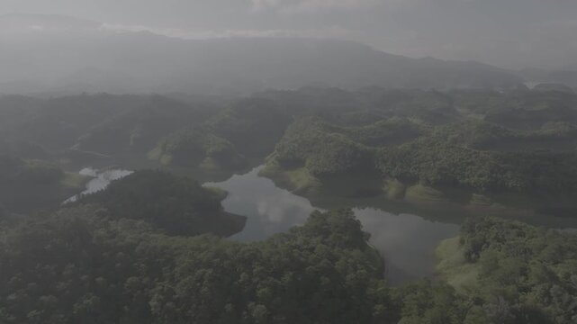 Cinematic aerial shot of scenic island landscape over Ta Dung Lake in Ta Dung Commune, Dak Glong, Dak Nong, Lam Dong Province, Vietnam. D log mode