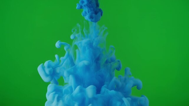 Blue ink cloud blooming in water against a green screen background with cinematic motion