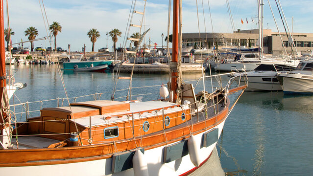 Traditional Wooden Sailboat and Modern Yachts in Cassis Harbor France