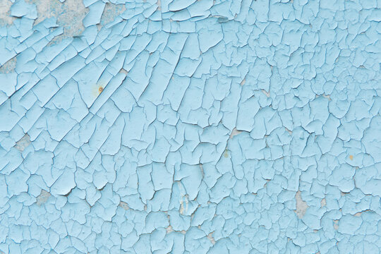 Textured blue background with cracked paint suitable for various uses in design and artwork